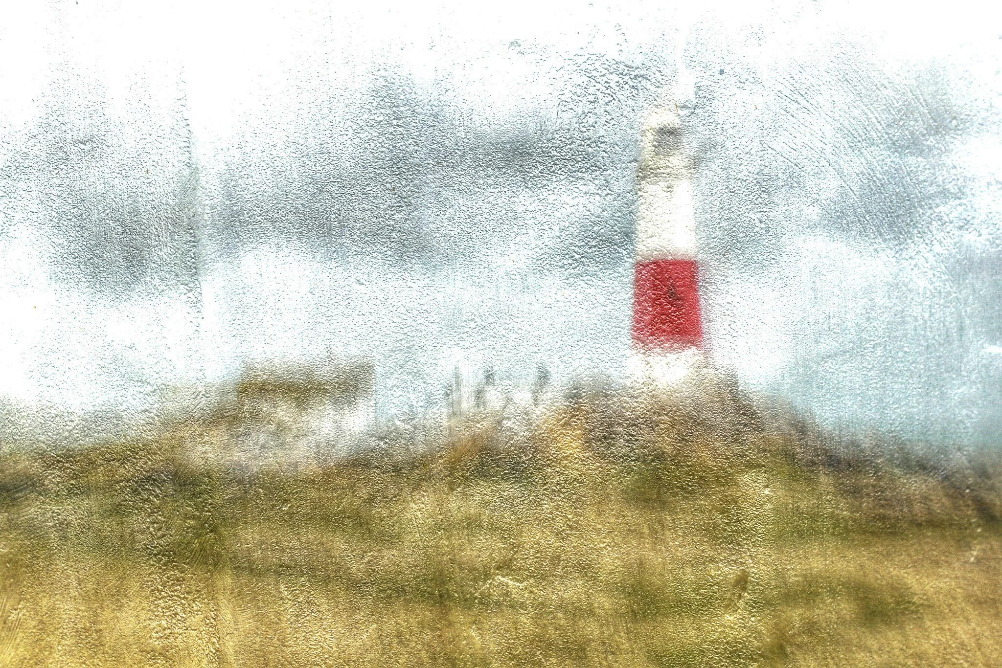 Abstract image of a red and white lighthouse and cottages set against a metallic background.