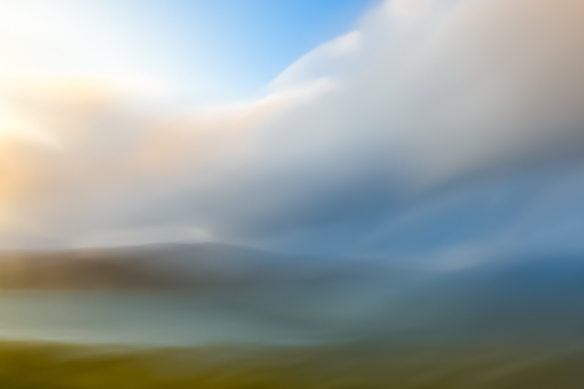 Abstract landscape with sea, sky, clouds and hills.