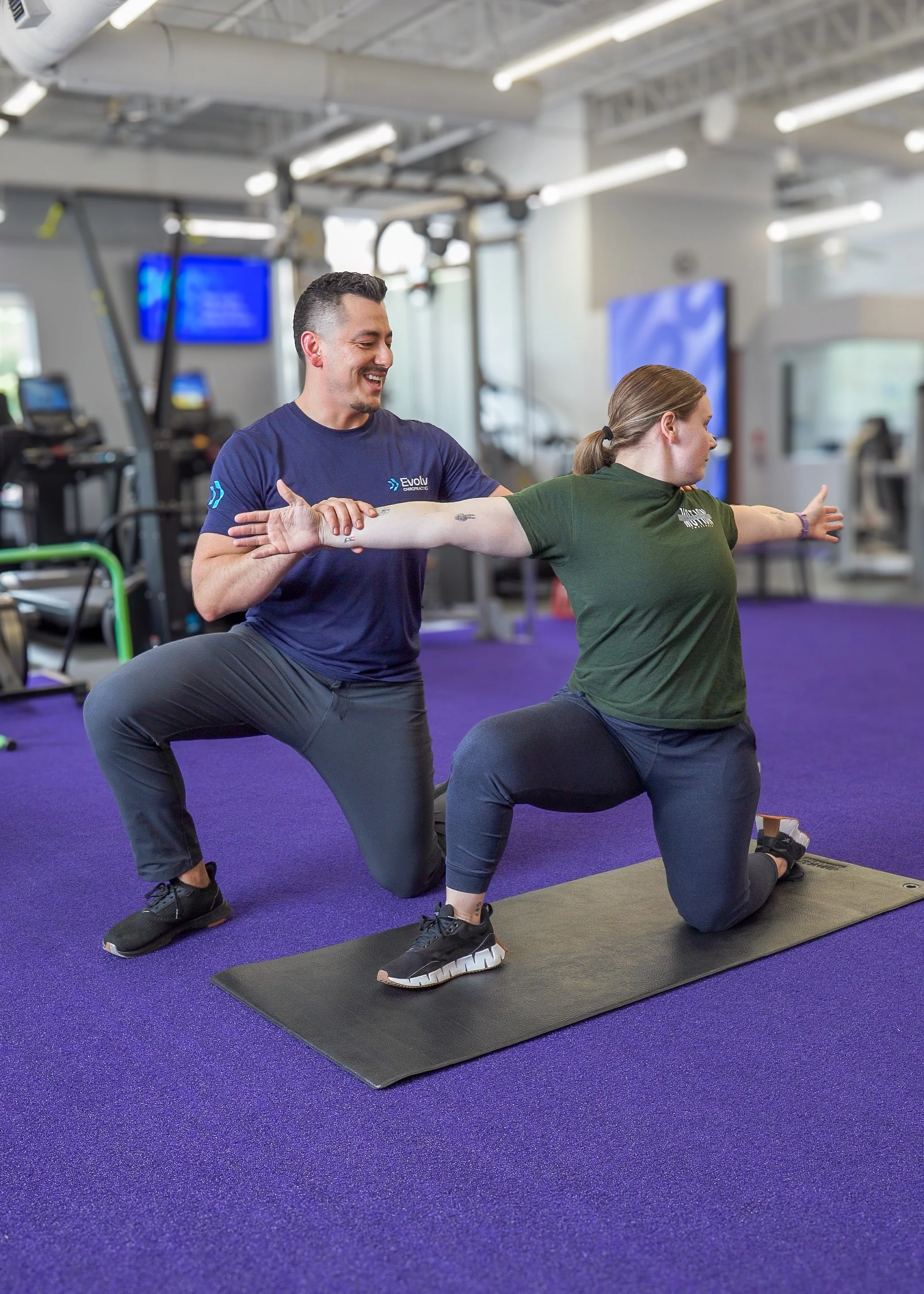 Dr. Cruz Orona guiding mobility exercise during one-on-one rehab session in Dallas clinic