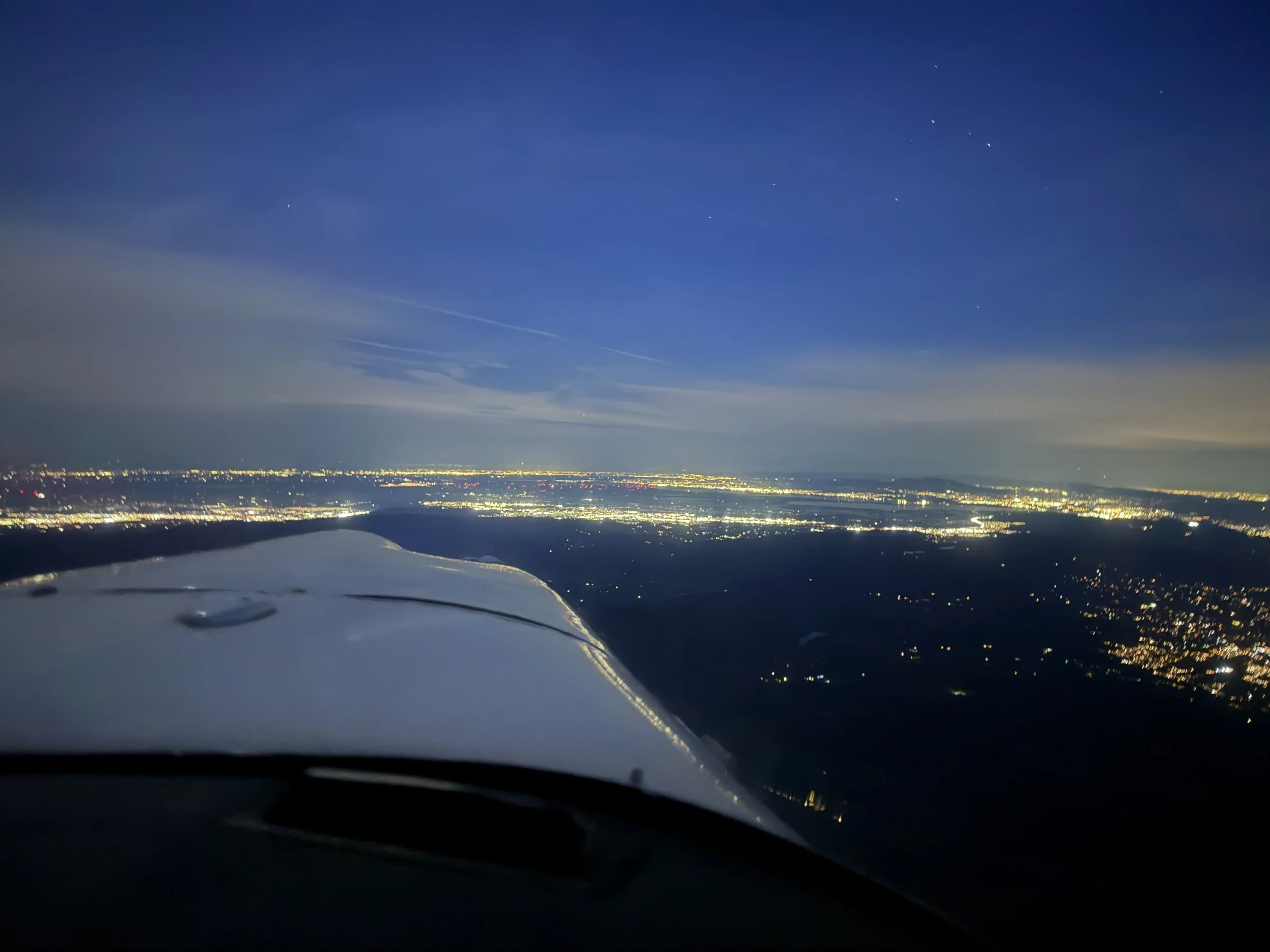 Nighttime aerial view of a city of Phoenix city lights, seen from the cockpit of N4824S, used for crew-style time building