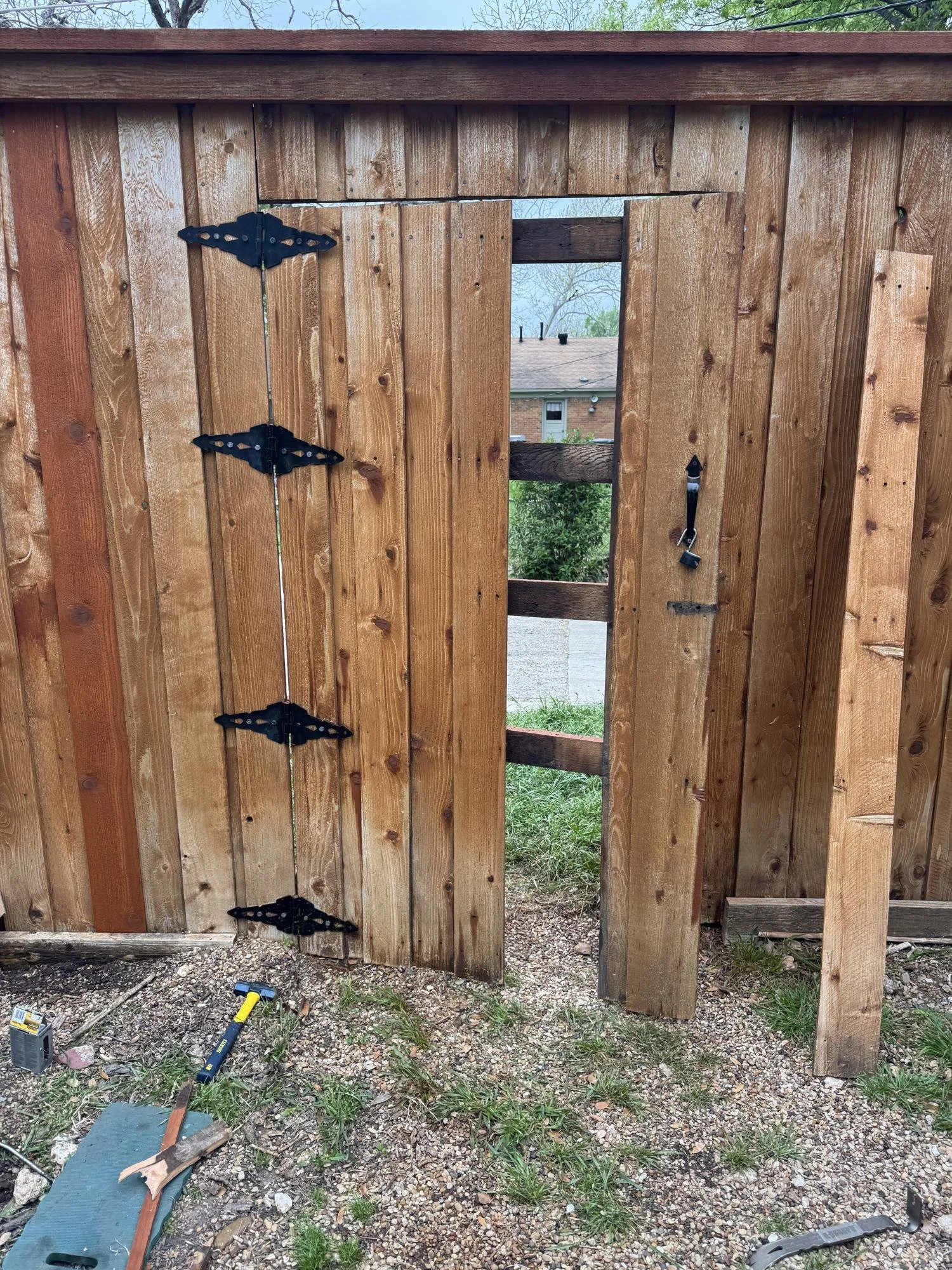 Fence gate being repaired before staining, Dallas