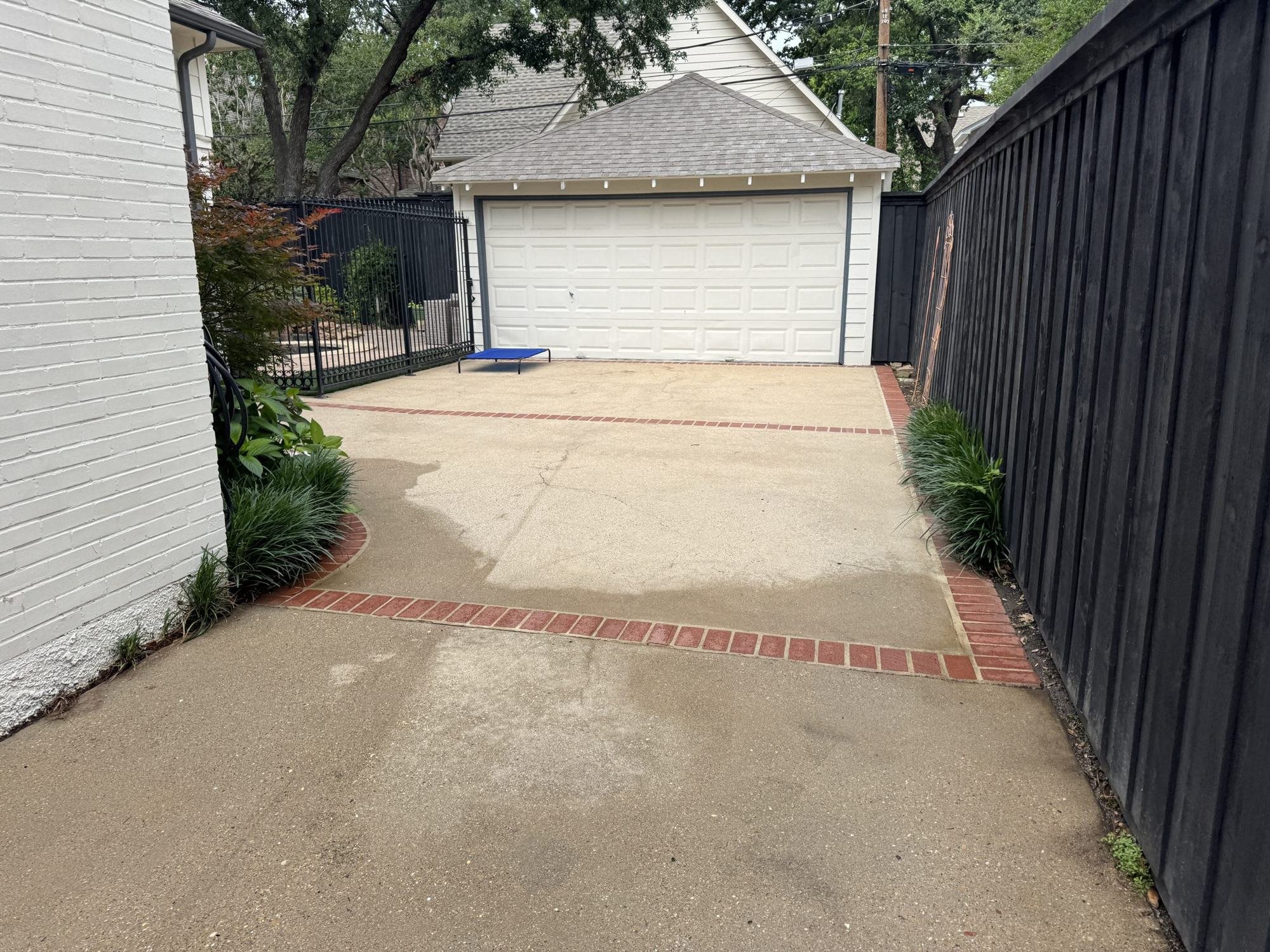 The same University Park driveway clean and bright after Spotlite pressure washing