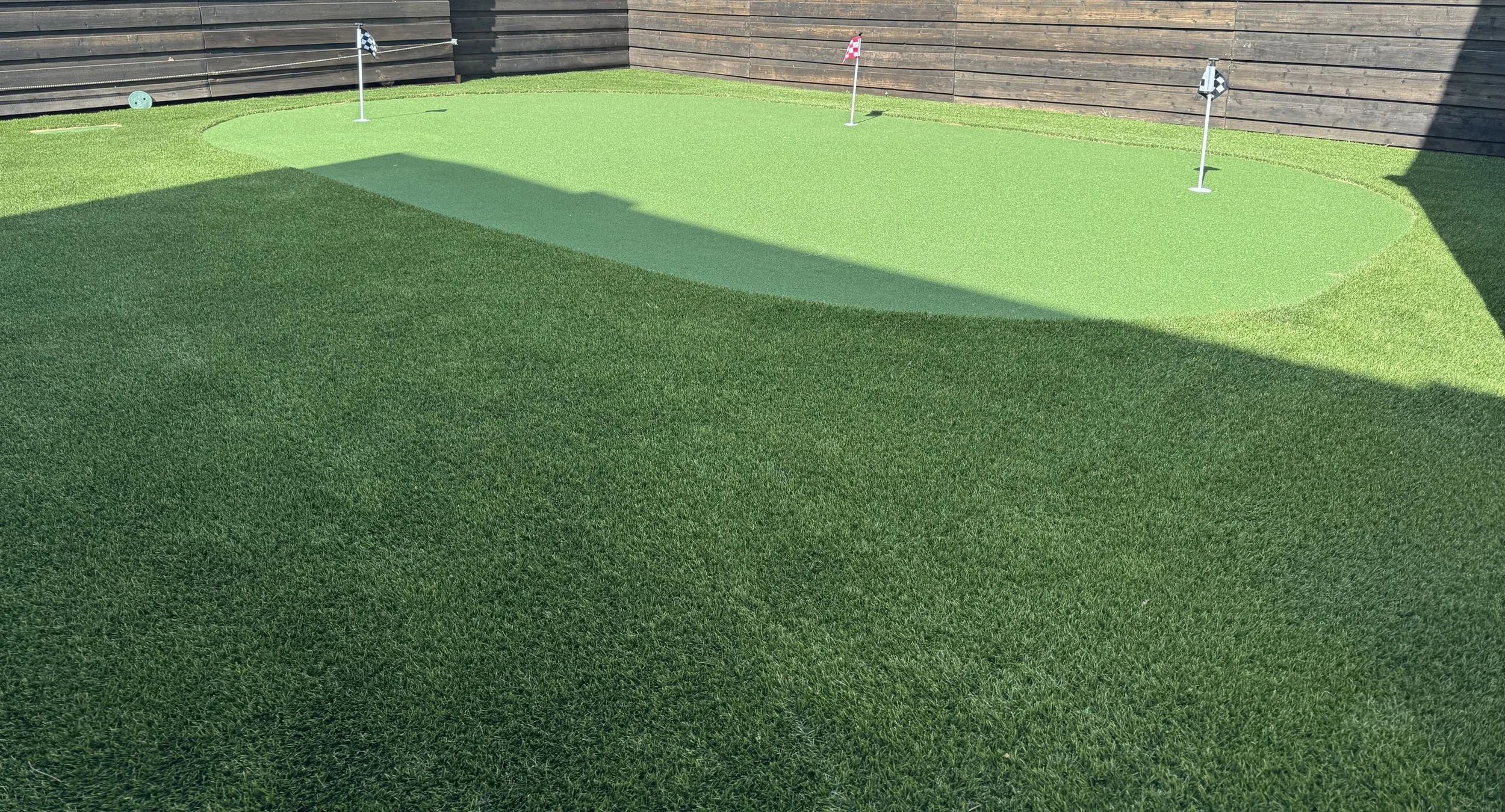 Custom backyard putting green installed by Spotlite in Dallas