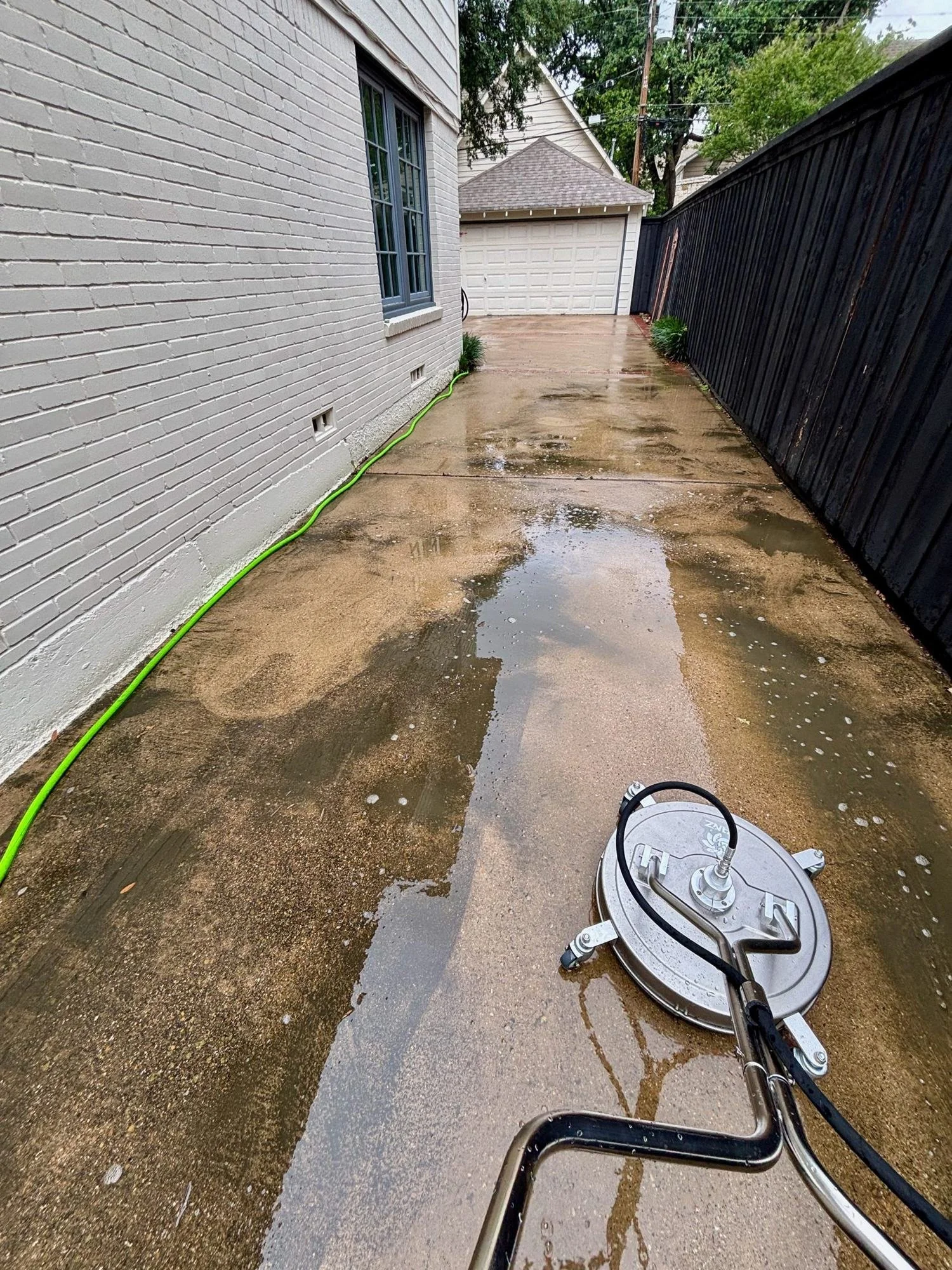 Clean concrete emerging beside grime during professional driveway cleaning, Dallas