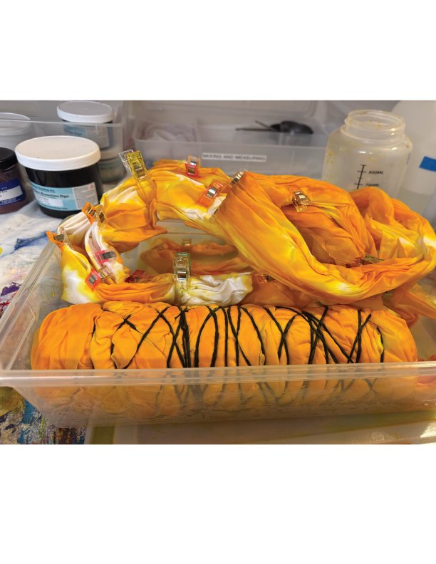 Bound and clamped yelow orange silk organza in a dye lab setting