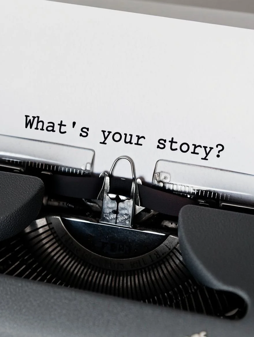 A close-up of a typewriter with a paper inserted, displaying the question 'What's your story?'
