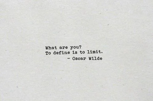 Typewritten quote on paper that reads, "What are you? To define is to limit. - Oscar Wilde."