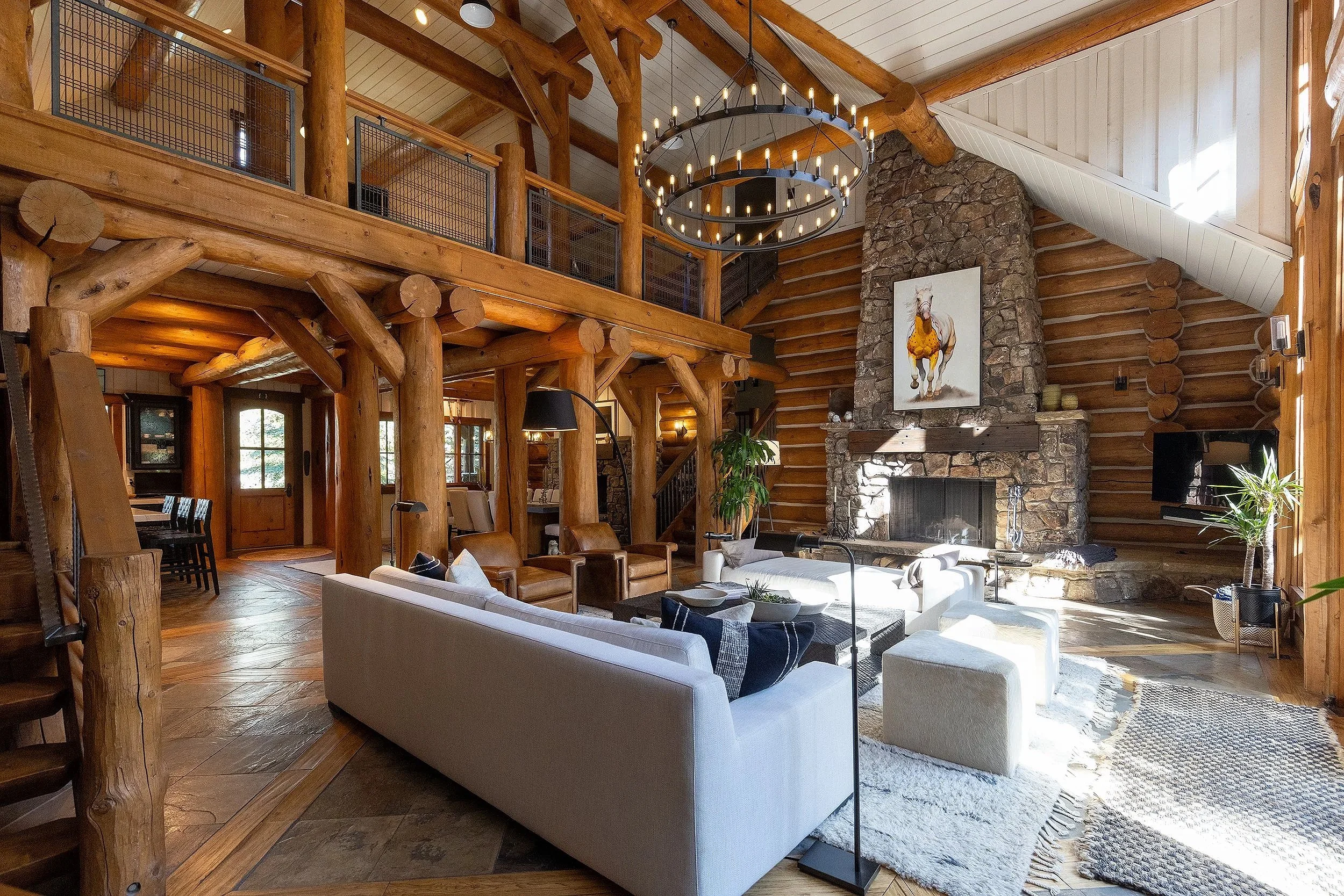 Beautiful western log home displaying "Crow War Pony-1" on stone fireplace