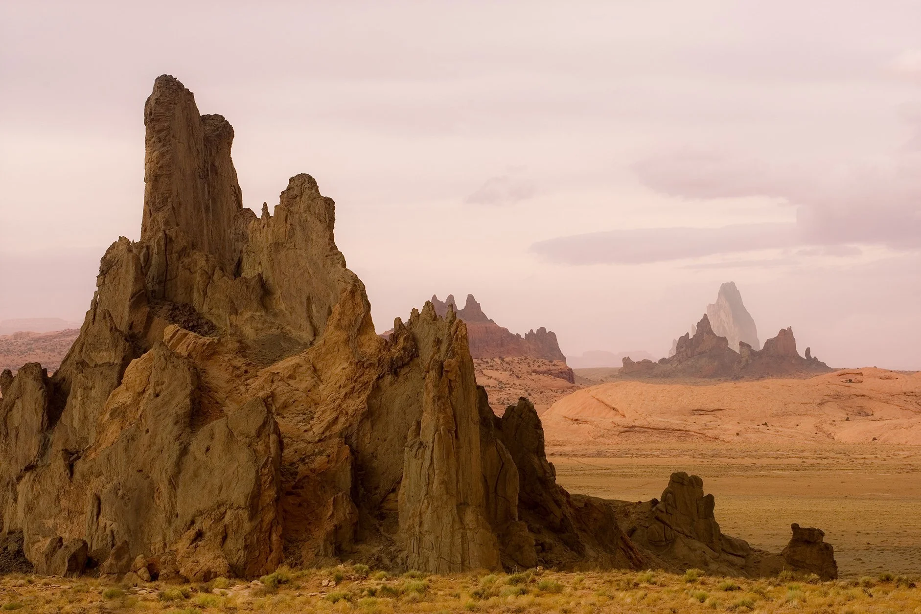 These monuments sandstone formations on the Navajo Nation in this art by Brady Willette