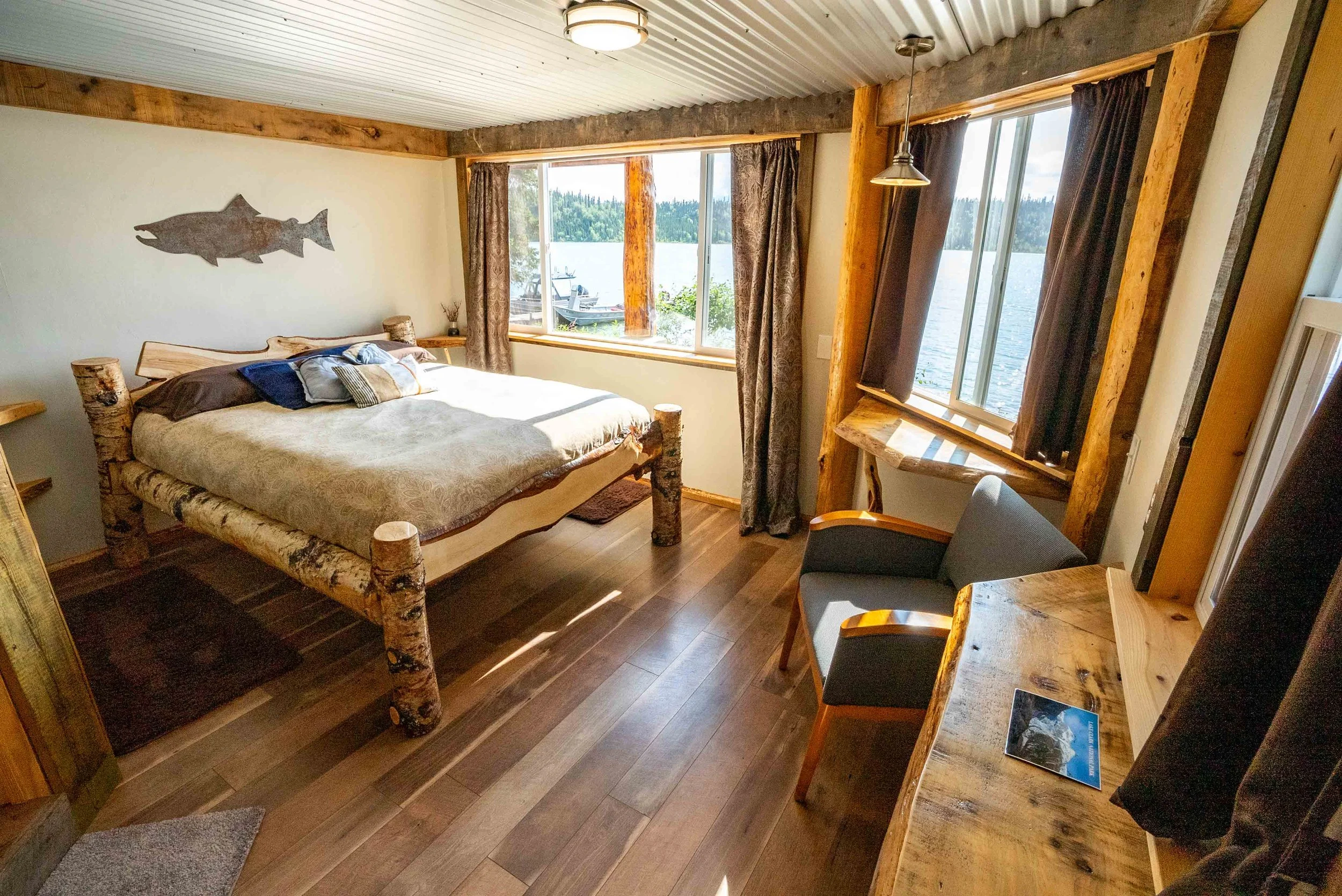 This queen bedroom and bath has a direct view of the lake. It sleeps two and features a dedicated workspace which looks right out upon the lake, along with another large picture window.