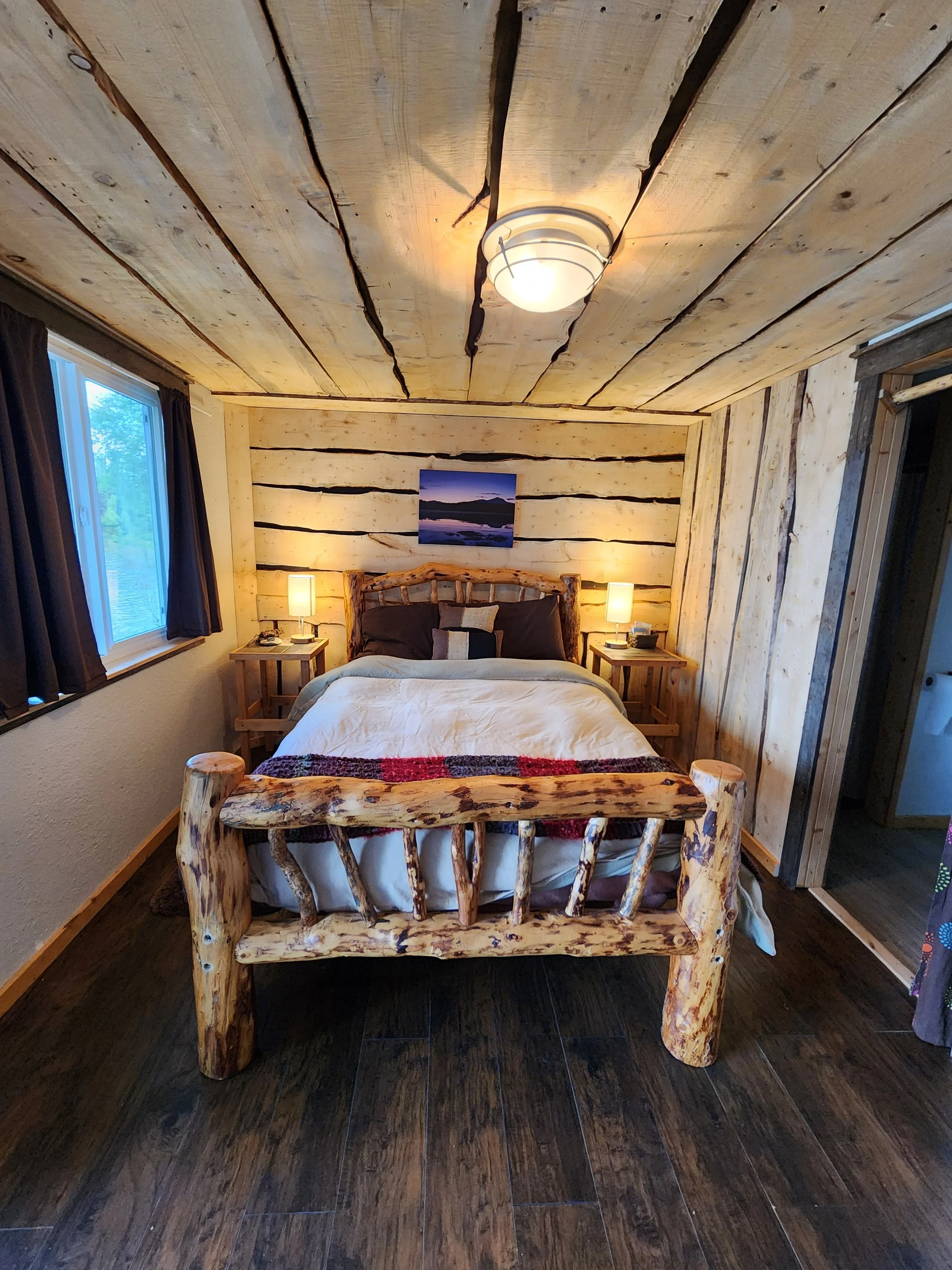 This room sleeps two and features a queen size bed and a full bathroom with step in shower. The private room has a direct view of the lake.