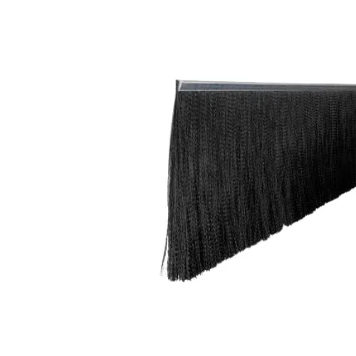 Close-up of a black broom dustpan with a textured surface and a slanted edge.