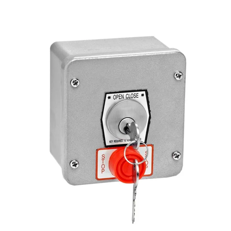 Emergency stop switch with a key and a red stop button on a gray metal box.