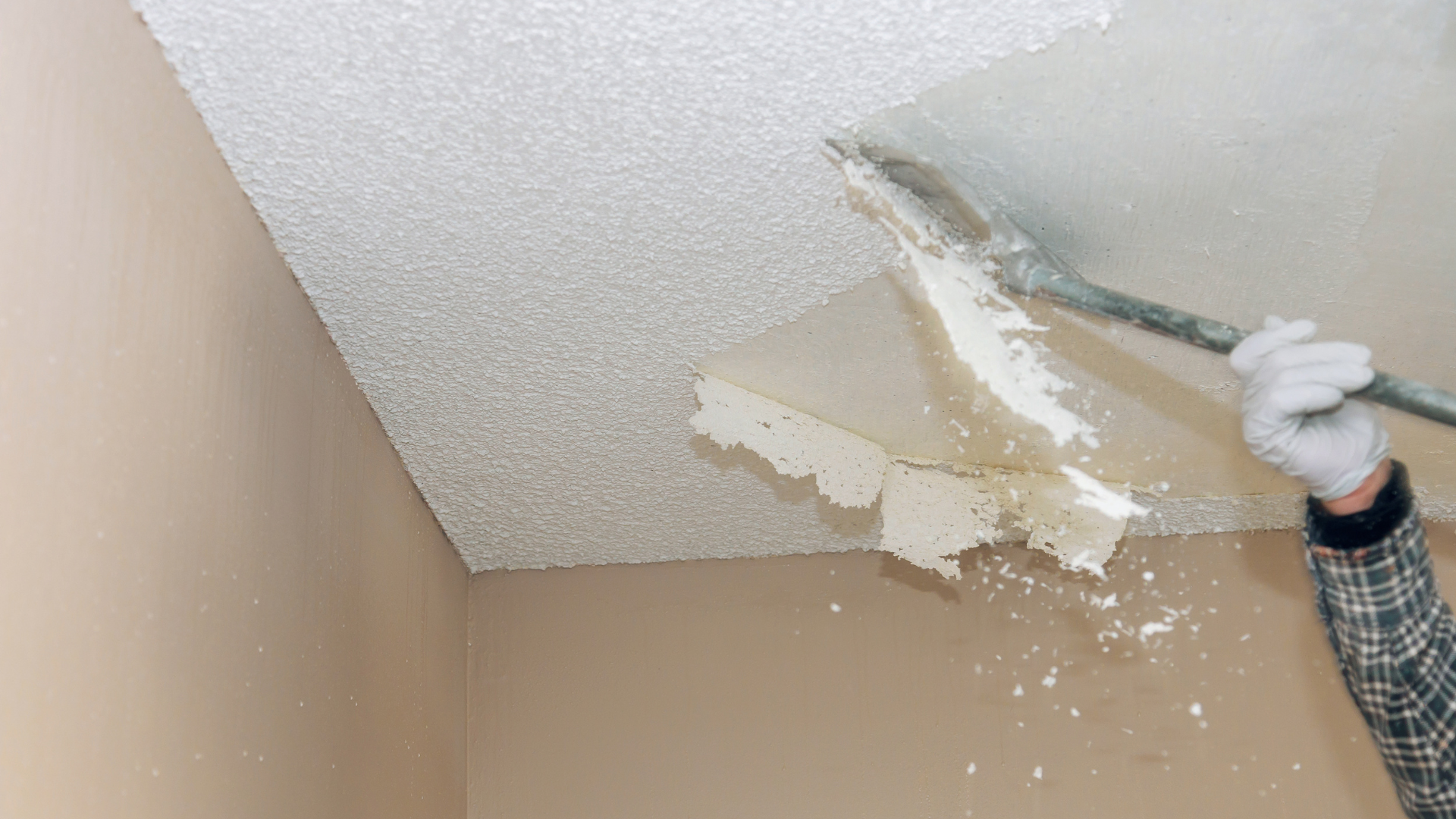 Contractor removing popcorn ceiling
