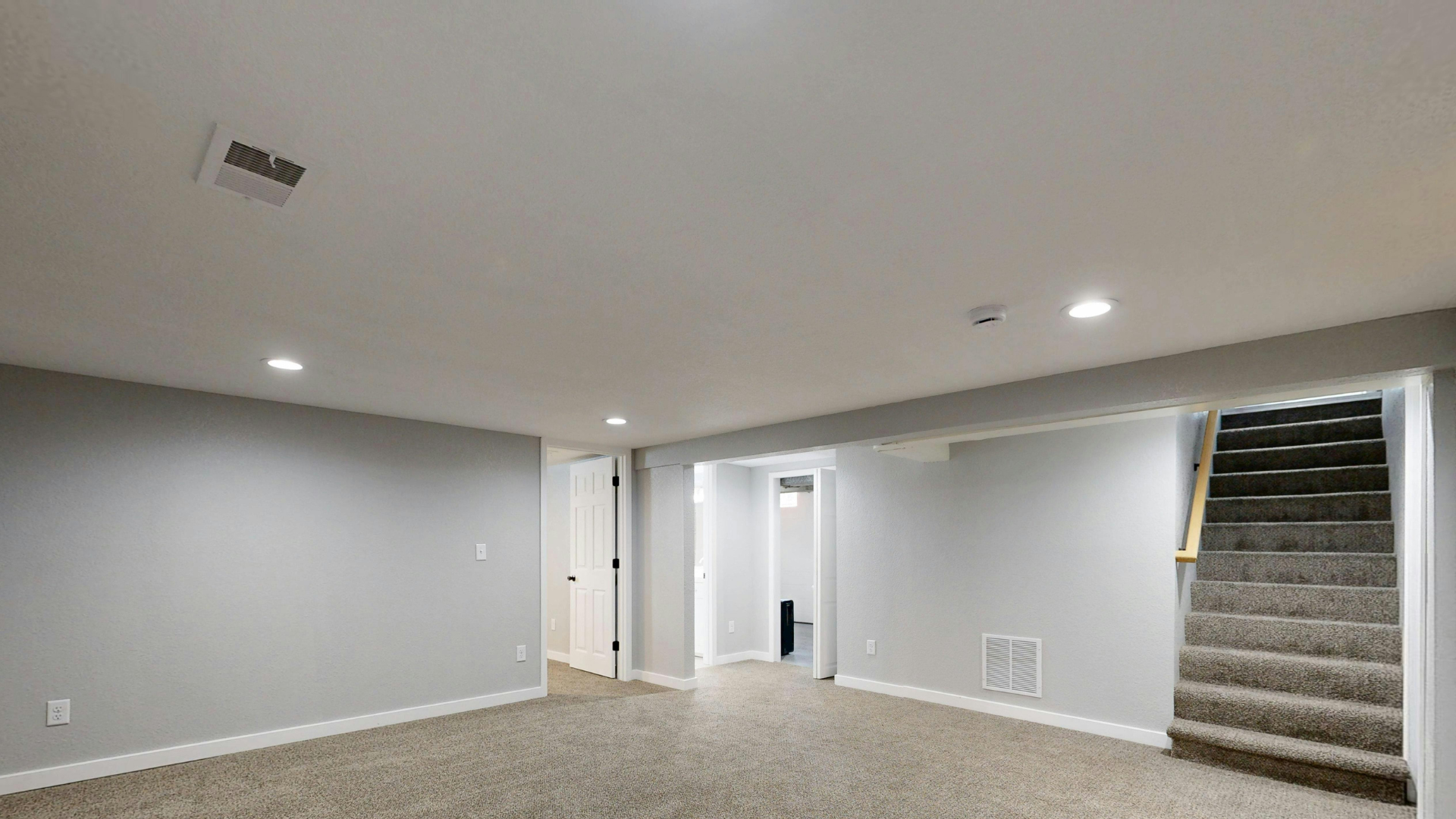 Newly renovated basement with new drywall and ceilings
