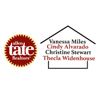 A real estate sign with the Norman Rockwell style house outline, featuring the names Vanessa Miles, Cindy Alvarado, Christine Stewart, and Thecla Widenhouse. The sign also displays the Allen Tate Realtors logo.