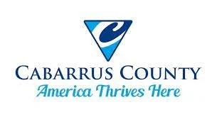 Cabarrus County logo with a blue and white emblem and the slogan 'America Thrives Here'.
