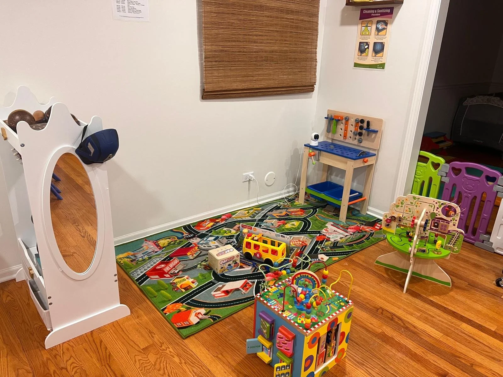 Kids' playroom with toys, a play mat, and a mirror.