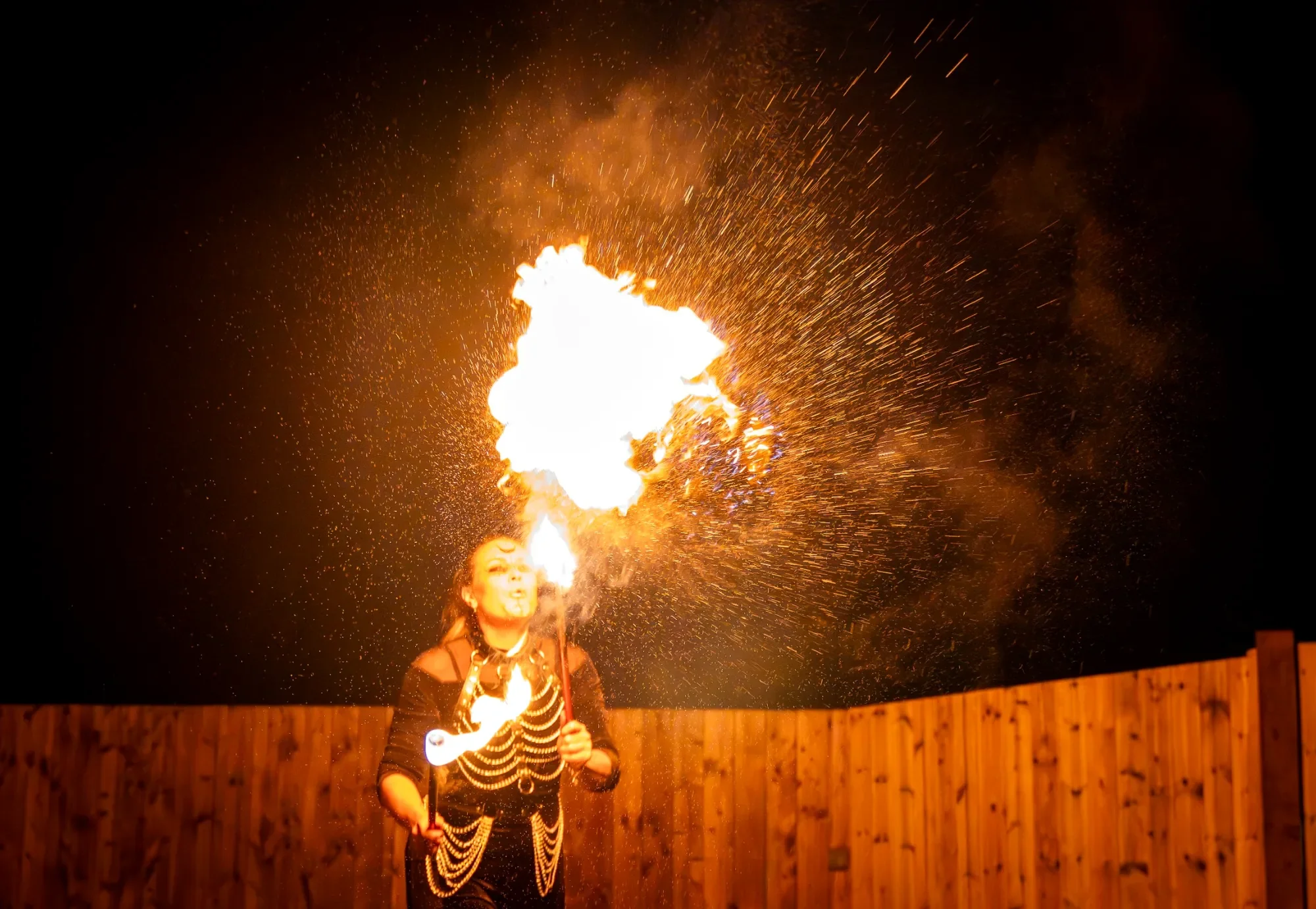 Fire breather performance at Yorkshire event with Photobox entertainment experience, sparks and flames captured at night