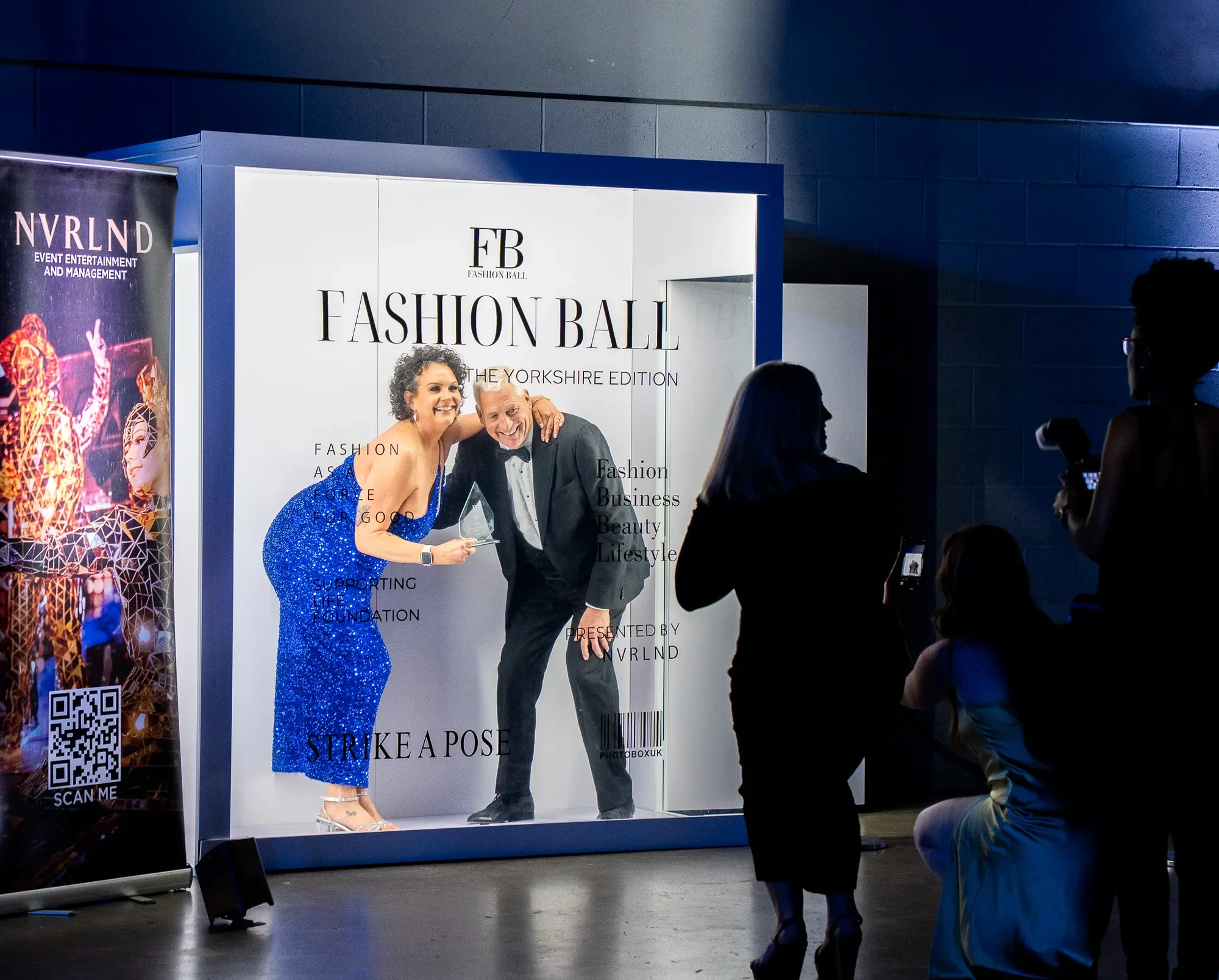 Fashion Ball Yorkshire event photo booth experience with guests posing in illuminated magazine-style Photobox setup