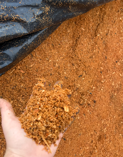 Close-up of dark, freshly tilled soil with small clumps and particles.