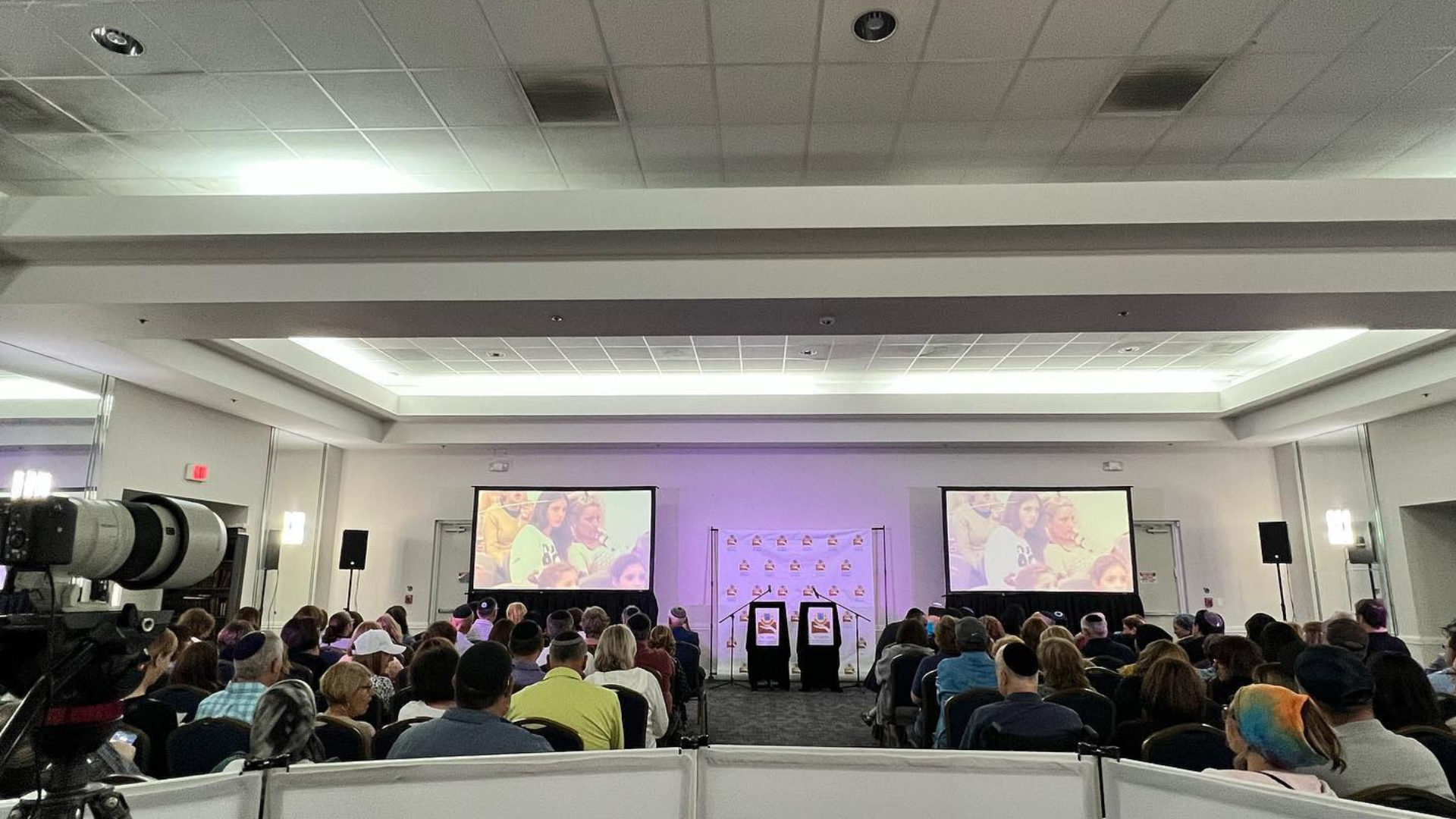 Projector screens with a live video feed of the speaker at a corporate event in Boca raton Florida by Baseline Studio