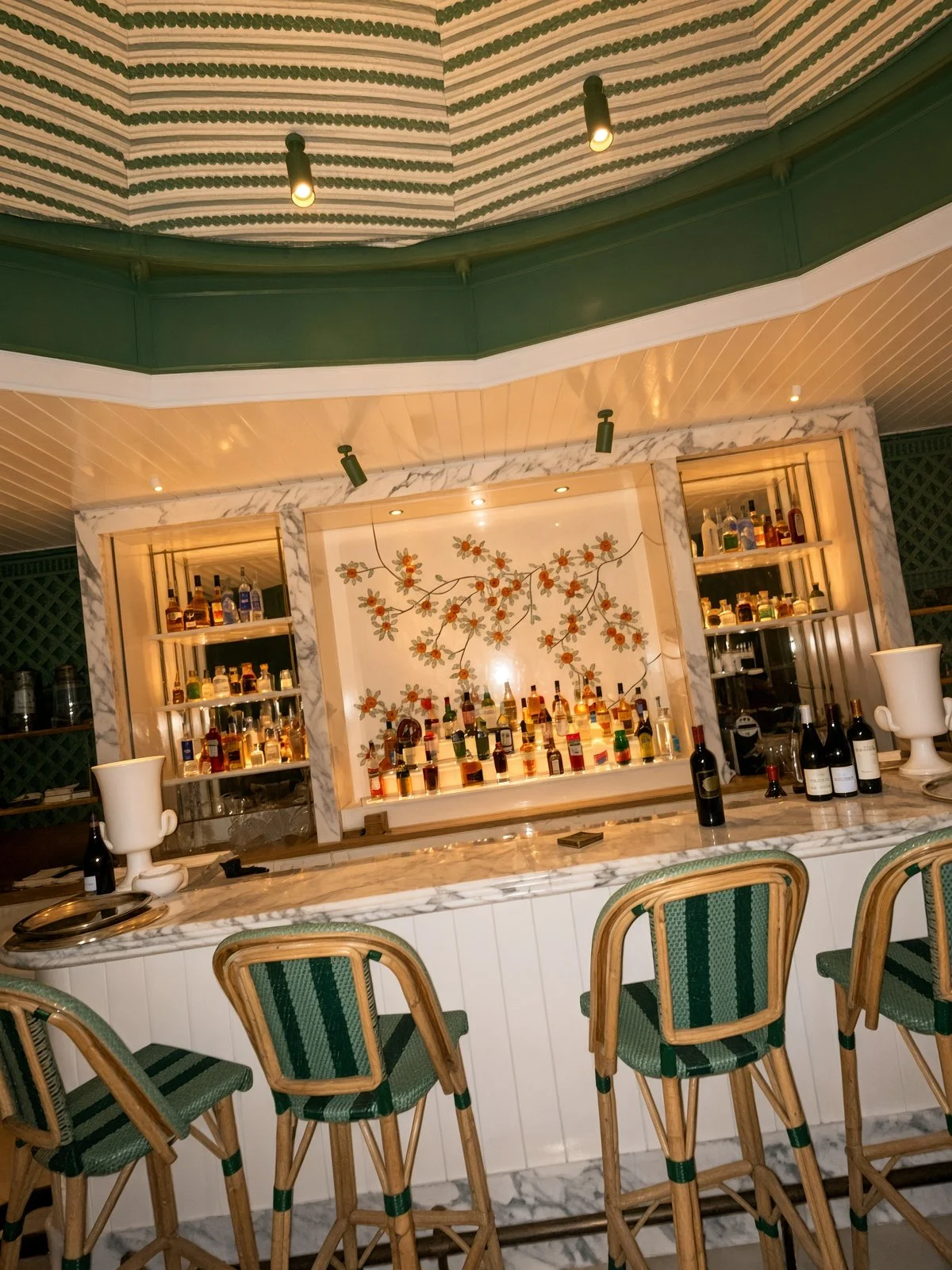 Terrace bar at Saint James Paris, with marble counter and green bistro stoolsThe terrace bar. Saint James runs as a private club as well as a hotel, which is exactly why it stays this quiet.
