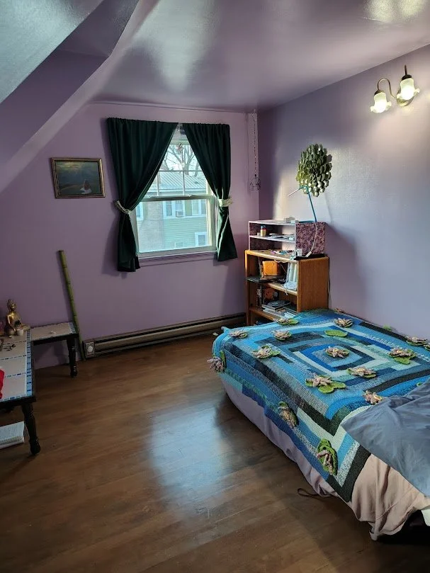 Small bedroom with window and bed