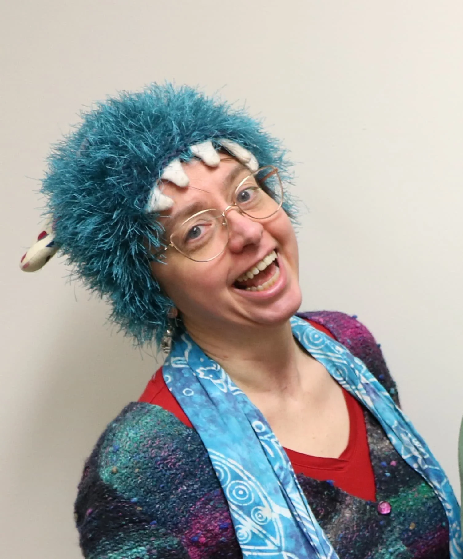 Happy woman wearing fuzzy blue hat and scarf