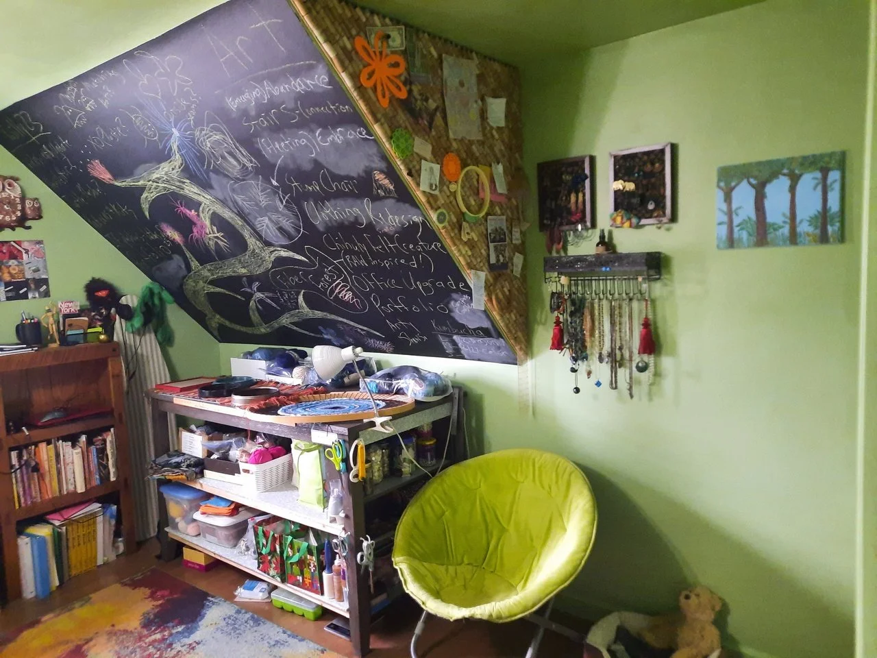 Green room with book shelves and chalk board slanted wall