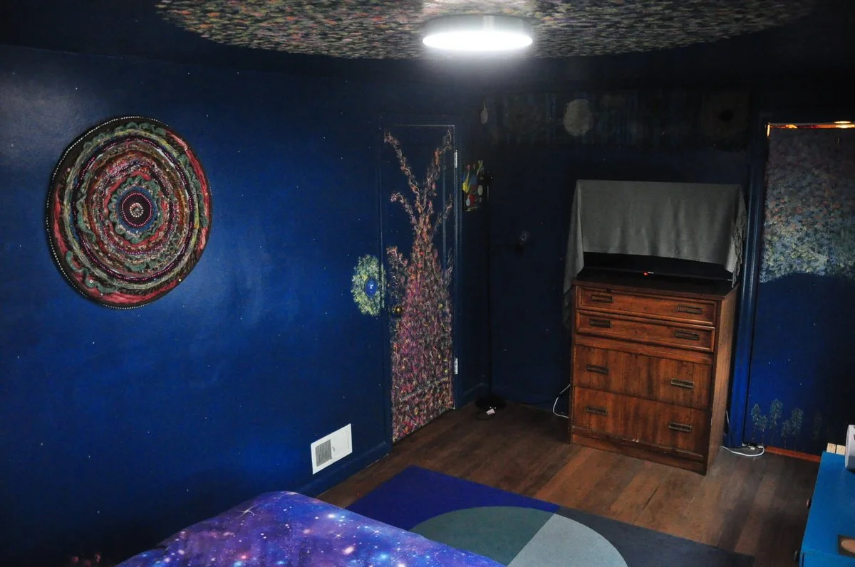 Blue painted room with art pieces on wall