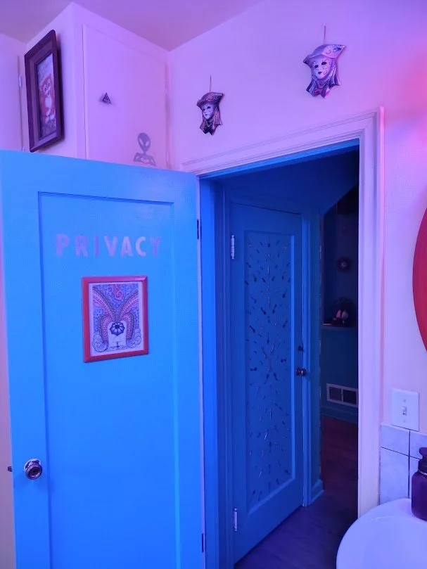 Blue door in house open with picture frame on door