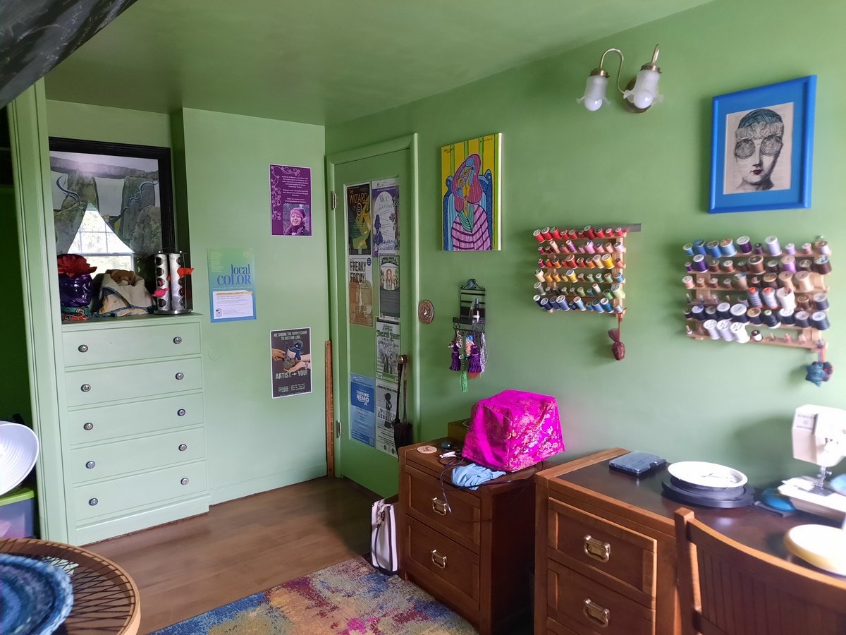 Colorful custom art pieces in green bedroom