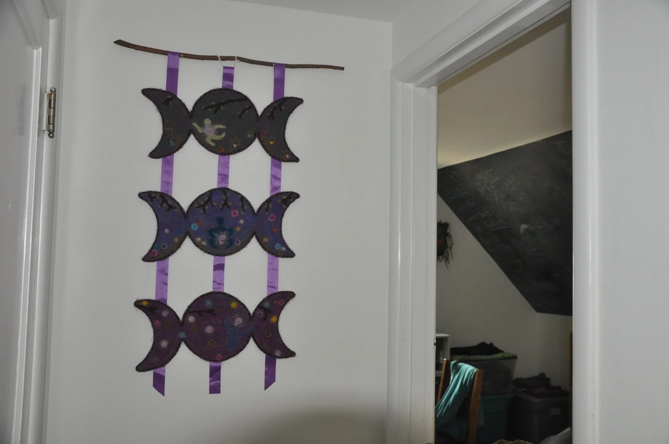 Moon art piece on house door