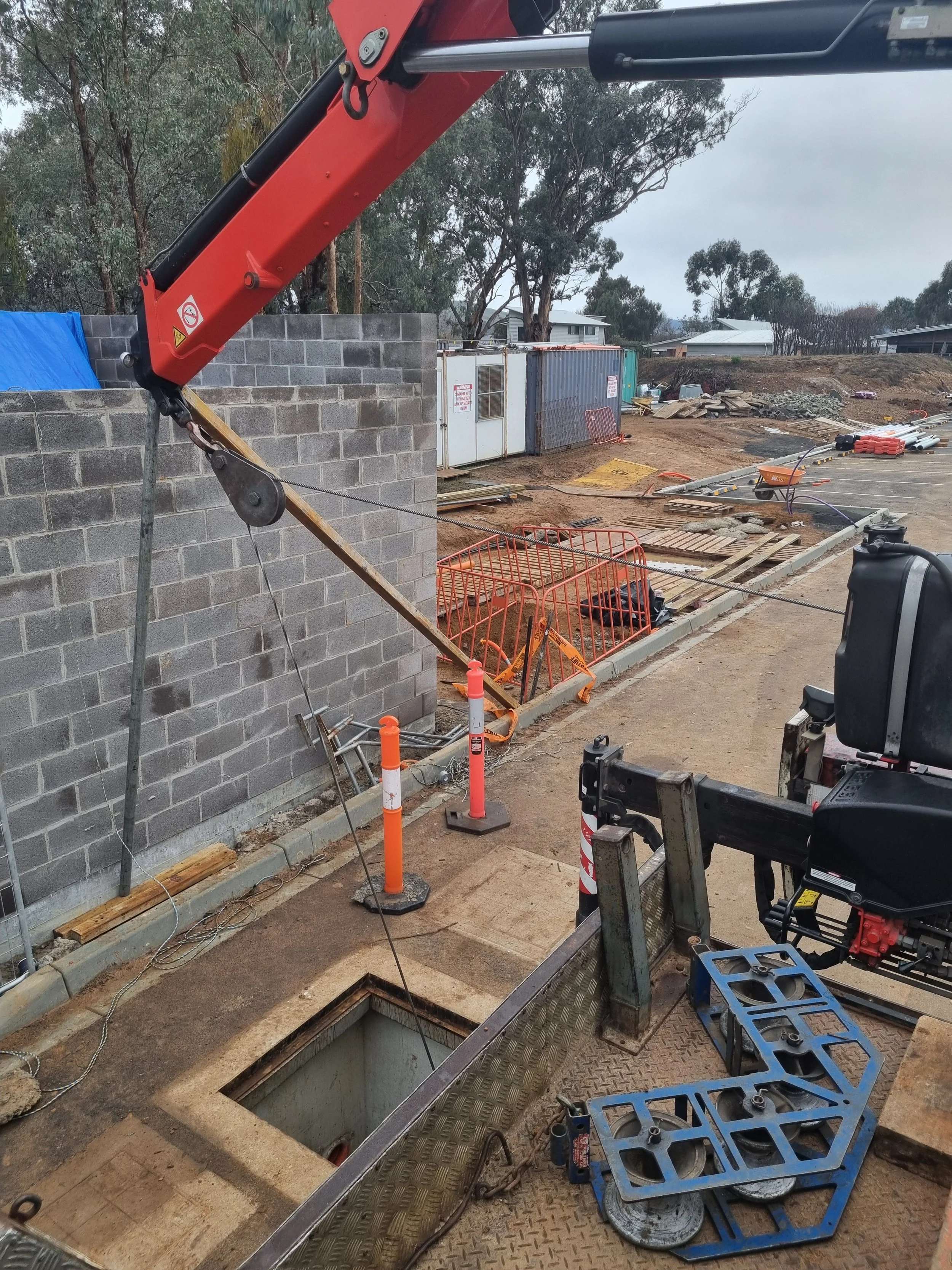 Creativity using our crane and pullies, to pull cable out from a pit