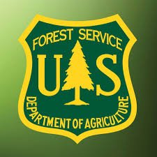 U.S. Forest Service emblem with a green background and yellow text and border.