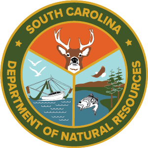 South Carolina Department of Natural Resources emblem featuring a deer head, a fishing boat, a fish, a bird, and a tree within a circular green and gold border.