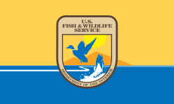 U.S. Fish and Wildlife Service emblem on a yellow and blue background.
