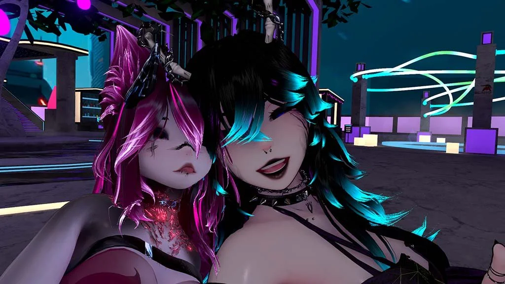Two animated characters with vibrant hair colors, one pink and the other black with blue streaks, taking a selfie at a neon-lit virtual nightlife scene.