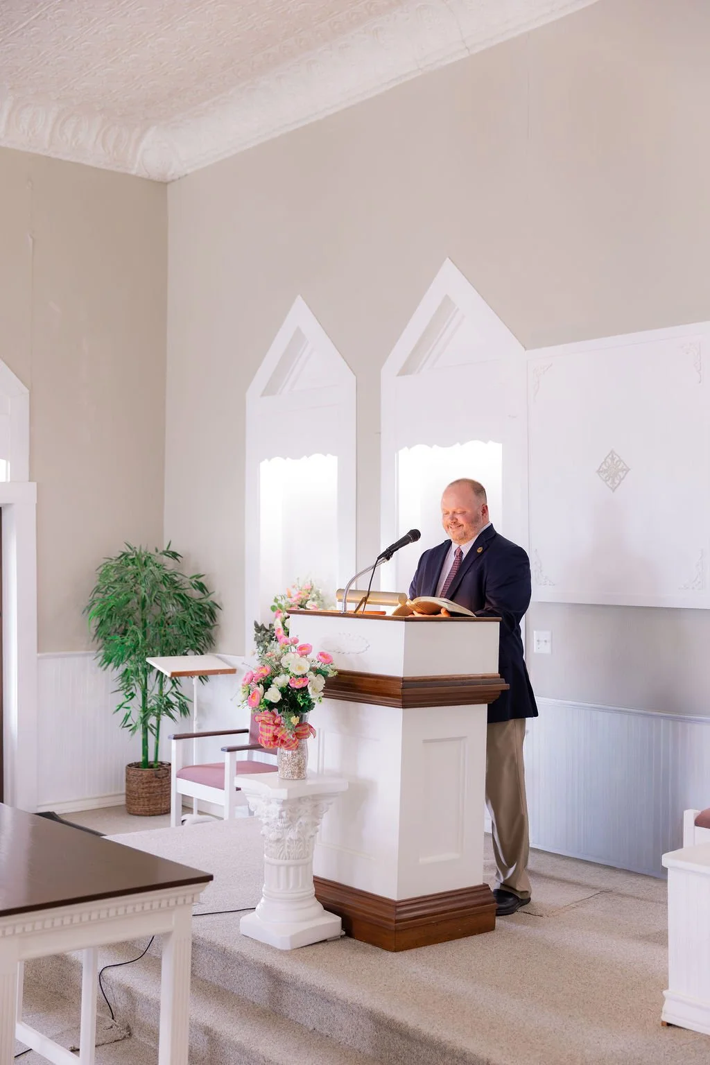 Chris Savage, the Normangee church of Christ's preacher, standing behind the pulpit