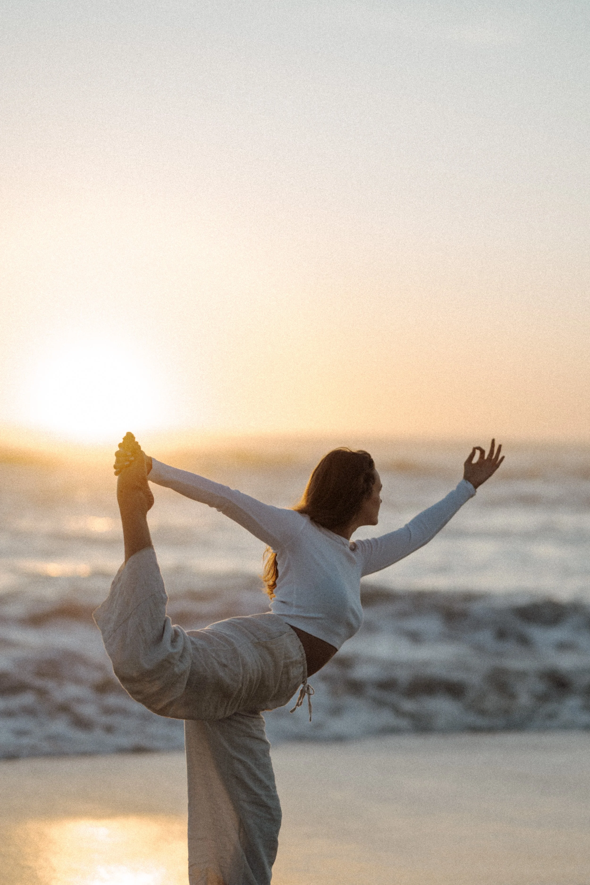 Alina on the beach doing yoga pose