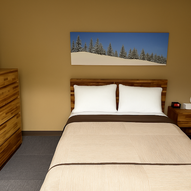 Hotel room with a bed, two pillows, wooden furniture, and a landscape painting of snow-covered trees.