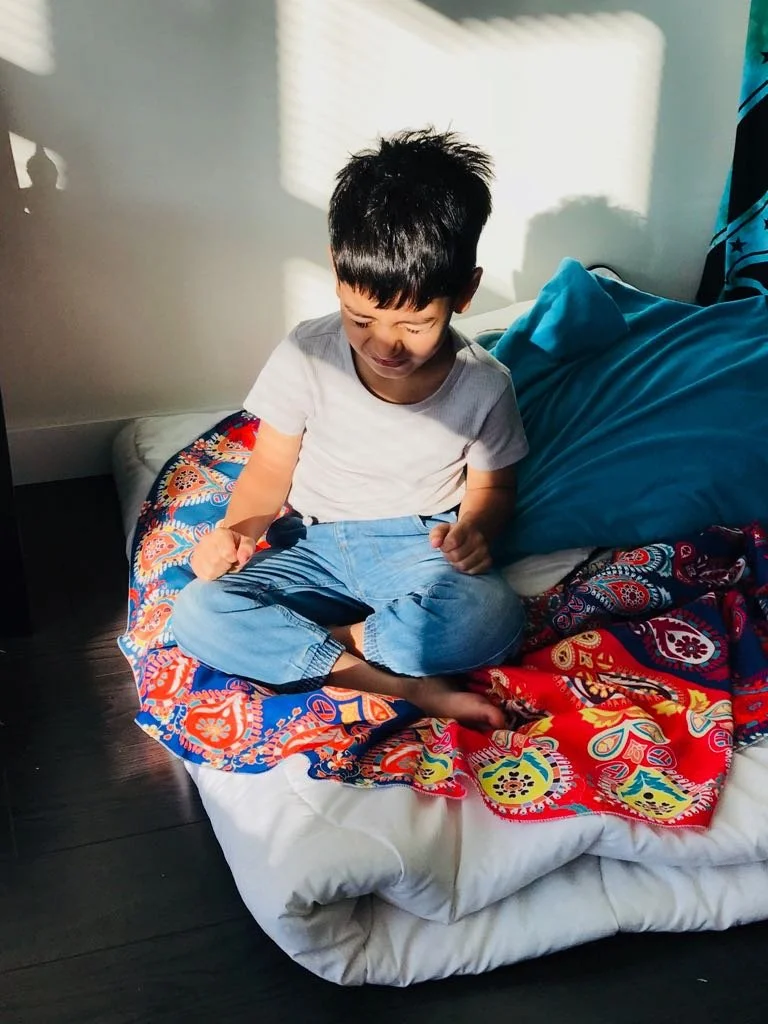 Child practicing mindfulness meditation at home to improve focus and emotional regulation