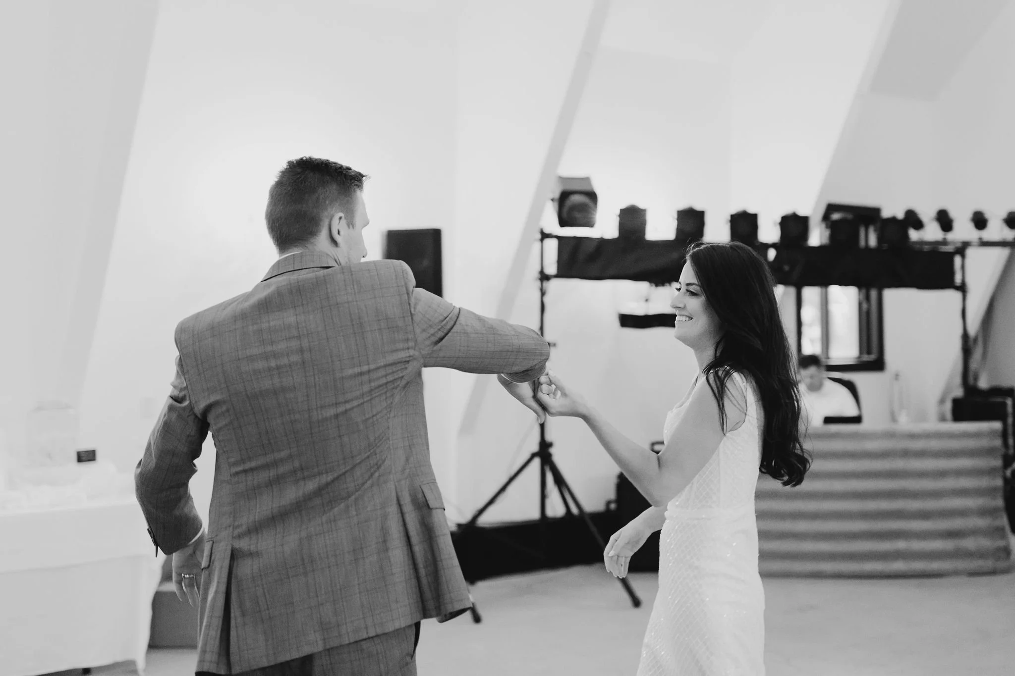 A couple dancing together in a room with professional lighting equipment in the background at The Yard, Moorhead Minnesota.