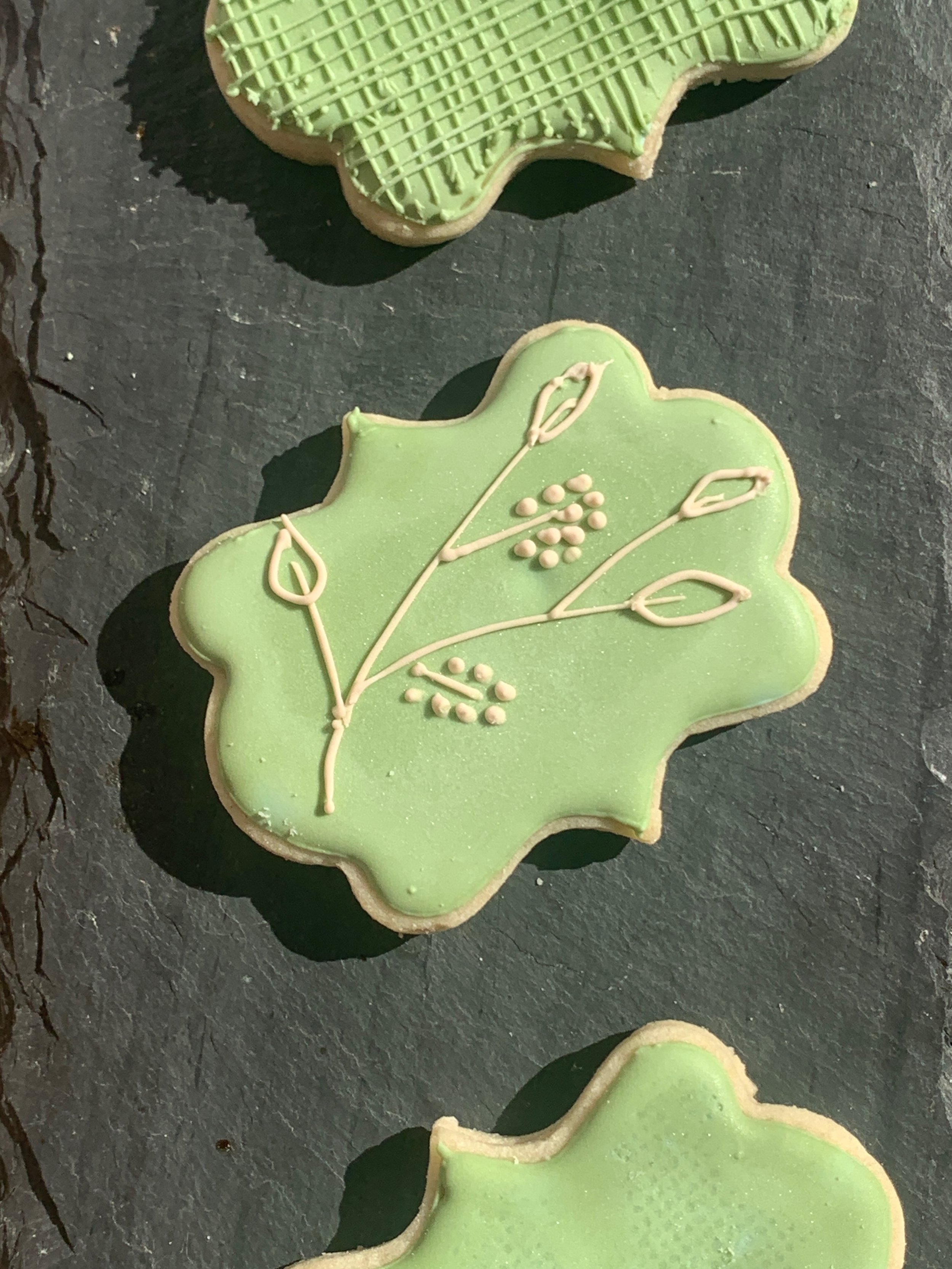 Spring Pistachio cookies, plaque shape on slate with botanical line art of pistachio branch