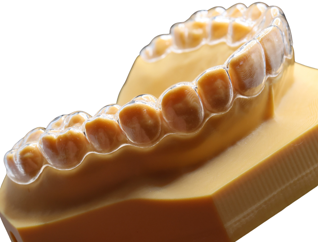 A close-up of a piece of yellow cheese with a cluster of caramel or butterscotch candies on top.