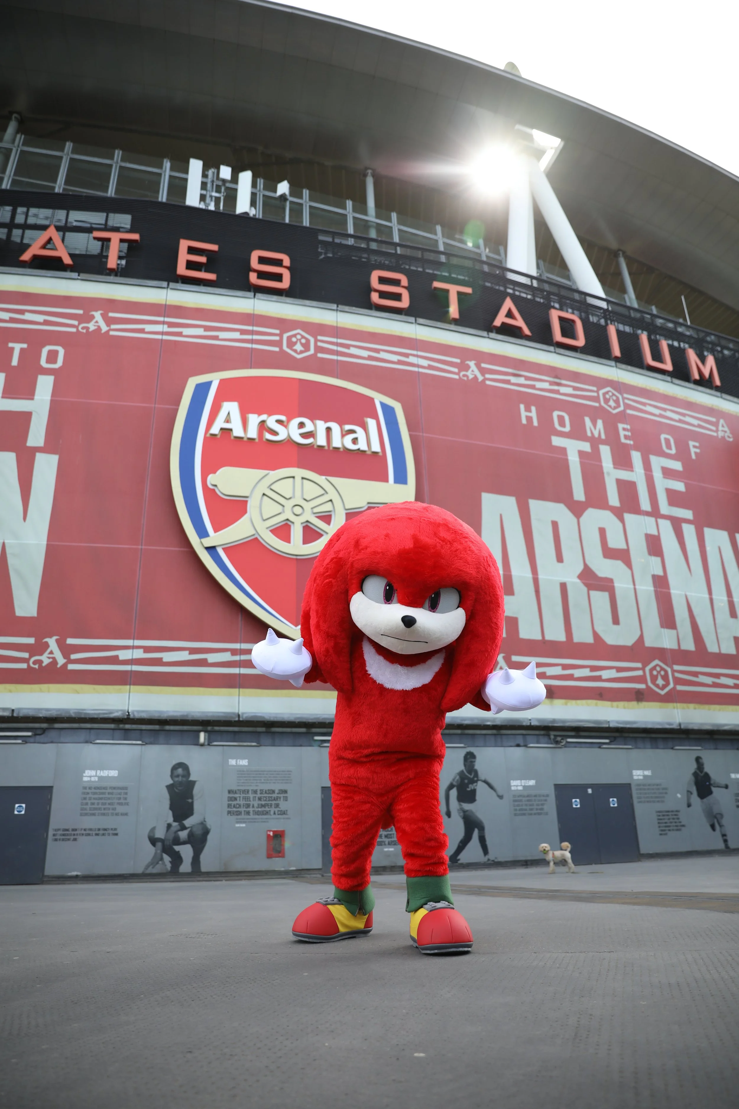 A Knuckles costumed character in front of Arsenal's Emirates Stadium