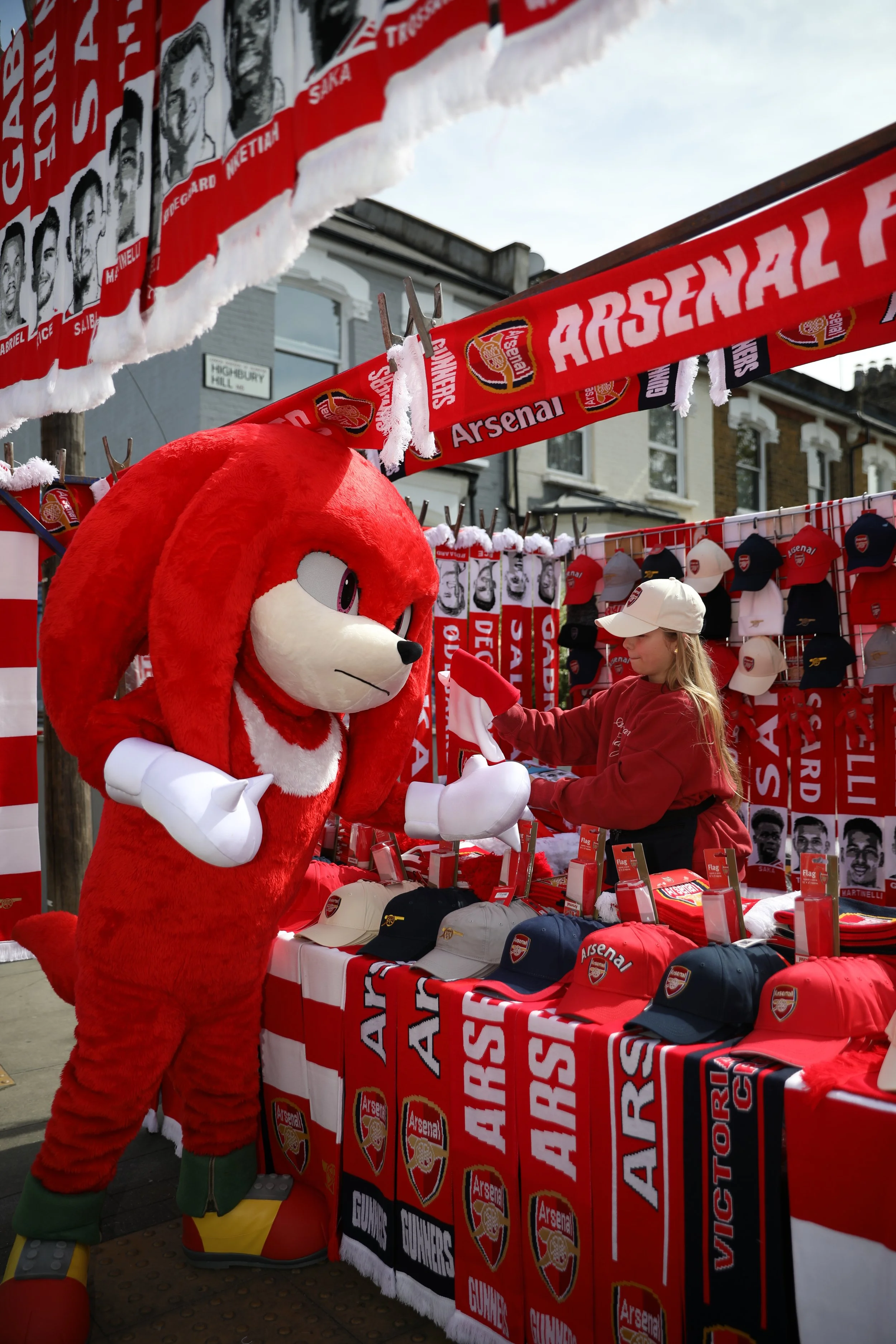 A Knuckles costumed character purchases Arsenal scarves
