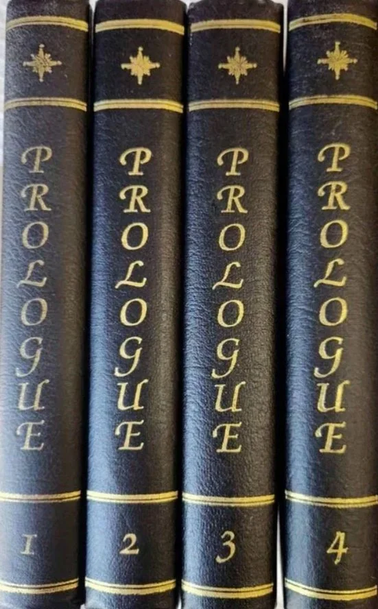 Set of five black leather-bound books titled "Propaganda" with gold lettering and decorative gold symbols on spines.