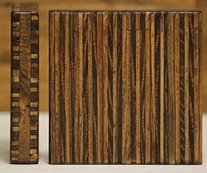 Close-up of a wooden board game with striped wood pattern and checkerboard edge.